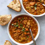 Lentil Turkey Soup served in bowls with bread