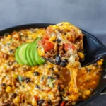 Cheesy Taco Rice Skillet in cast iron pan with toppings