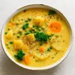 Creamy vegan potato soup served hot in a bowl