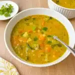 Vegetable Soup without Tomatoes in a white bowl with herbs