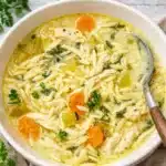 Creamy Lemon Chicken Orzo Soup in rustic bowl