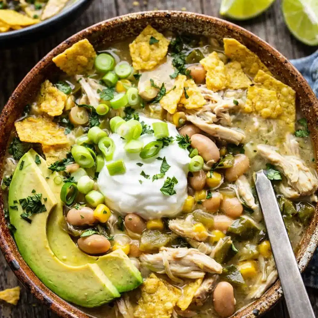 green chicken chili in a bowl with toppings