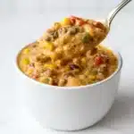 High Protein Creamy Taco Soup in rustic bowl with toppings