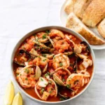 Cioppino seafood stew with crab, shrimp, and mussels in tomato broth