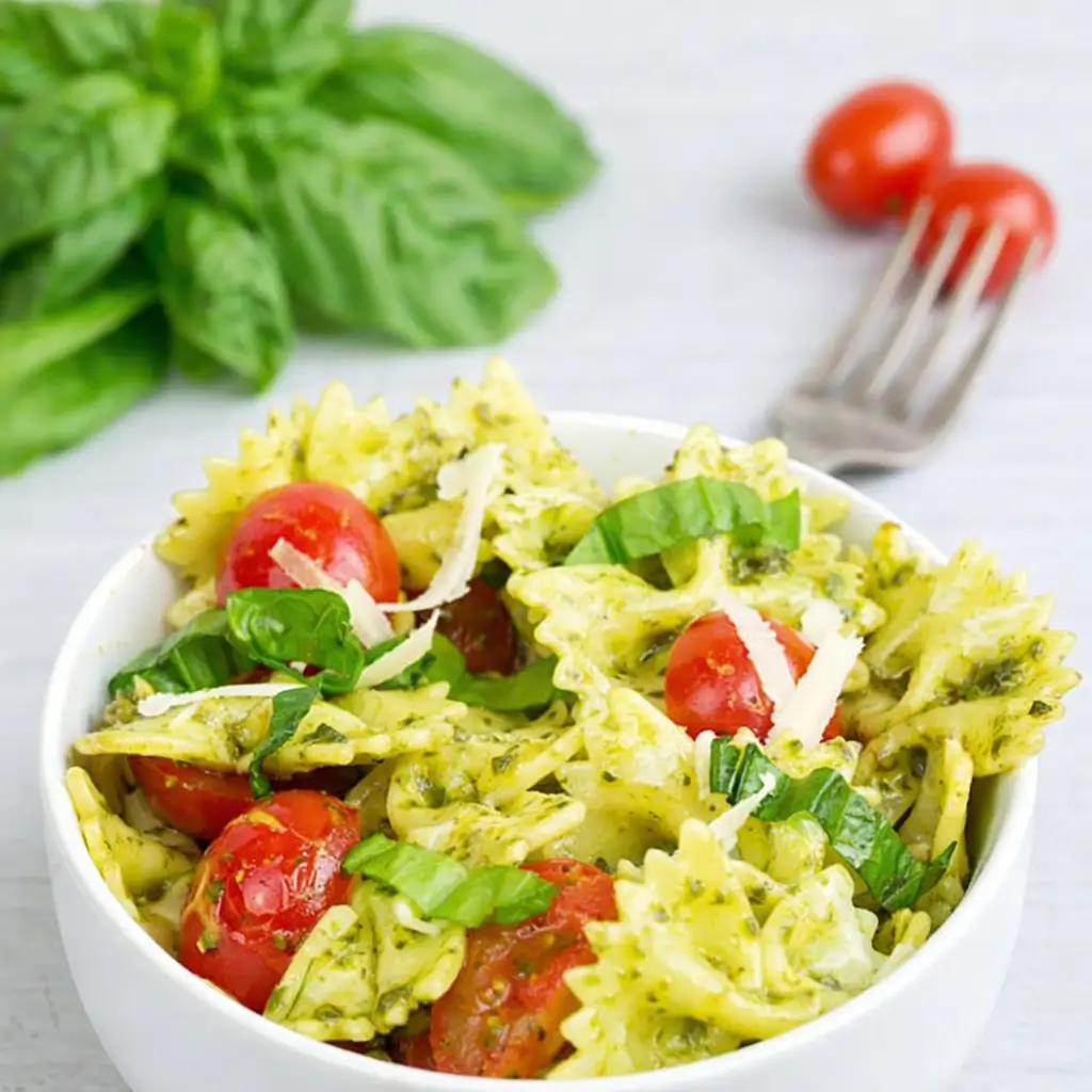 Pesto Pasta with Grilled Chicken served with basil and tomatoes