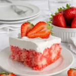 Strawberry Poke Cake slice with whipped topping