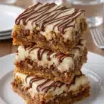 Cinnamon Roll Bliss Bars with cream cheese frosting on plate