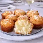 Portuguese Coconut Cakes on white plate in bright kitchen