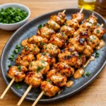 Bang Bang Chicken Skewers with creamy sauce and green onions